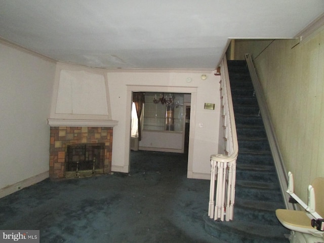 unfurnished living room with a stone fireplace and dark colored carpet