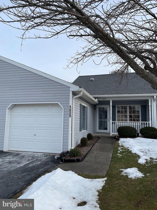 view of front facade featuring a garage and covered porch