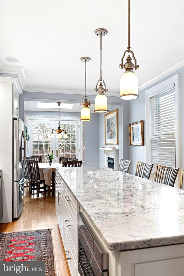 kitchen featuring pendant lighting, a center island, and white cabinets