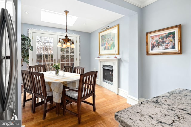 dining space with an inviting chandelier and light hardwood / wood-style floors