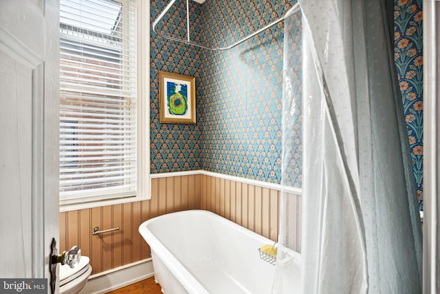 bathroom featuring a bathtub and toilet