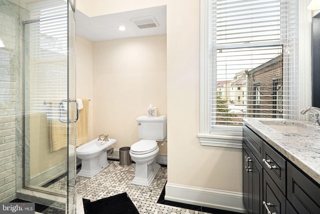 bathroom featuring tile patterned floors, toilet, a bidet, vanity, and a shower with door