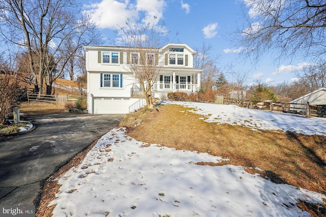 view of front property with a porch and a garage