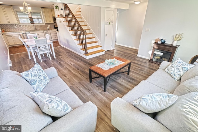 living room with hardwood / wood-style flooring and sink