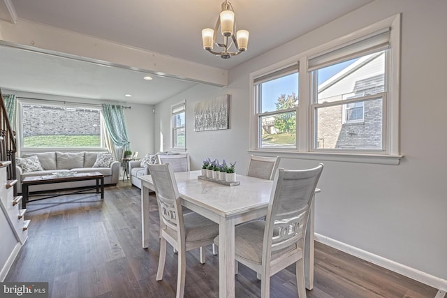 dining space featuring an inviting chandelier, dark hardwood / wood-style floors, and beamed ceiling