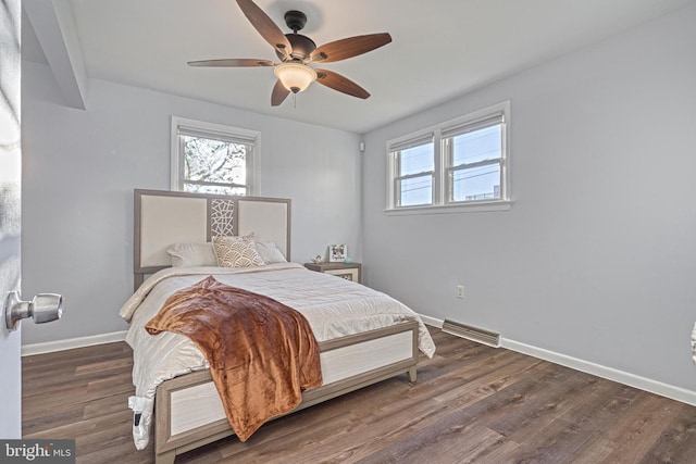 bedroom with dark hardwood / wood-style floors and ceiling fan