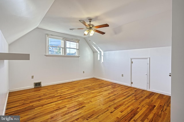 additional living space featuring vaulted ceiling, ceiling fan, and hardwood / wood-style floors