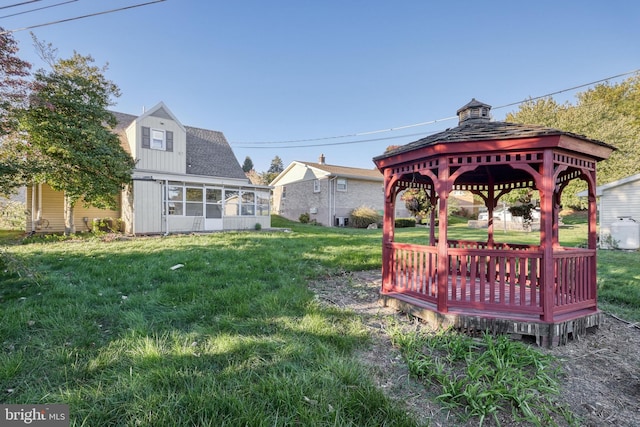 view of yard featuring a gazebo and a sunroom