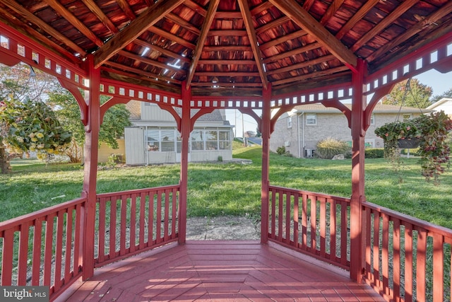 deck featuring a gazebo and a yard