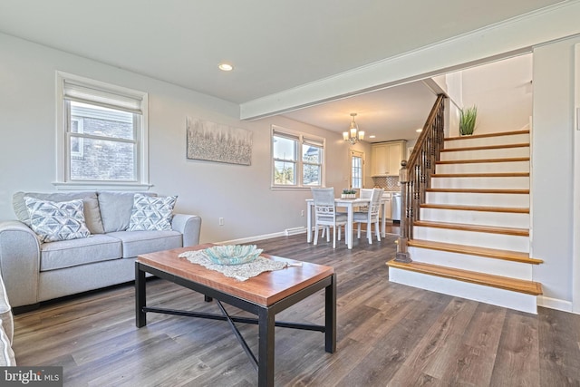 living room with beamed ceiling, dark hardwood / wood-style flooring, and a notable chandelier