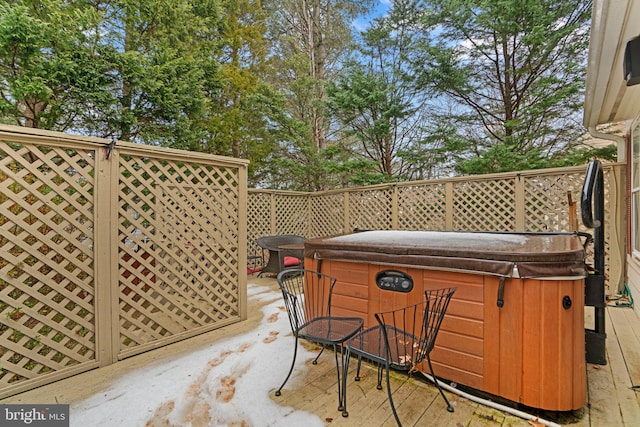 wooden terrace with a hot tub