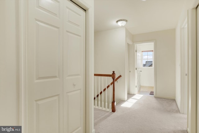 corridor featuring light colored carpet