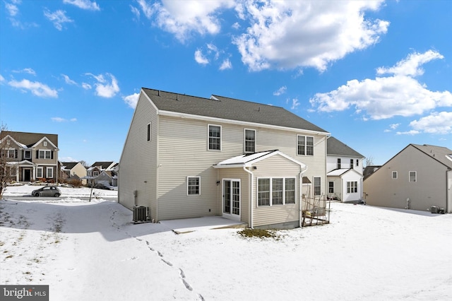 snow covered property featuring cooling unit