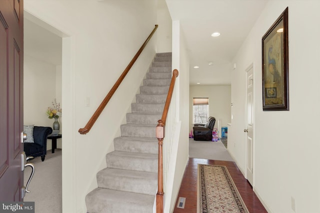 stairway with hardwood / wood-style flooring