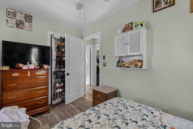 bedroom with ceiling fan and wood-type flooring