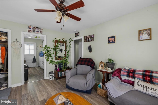 living room featuring ceiling fan and hardwood / wood-style floors