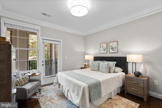 bedroom featuring dark wood-type flooring, ornamental molding, and access to exterior