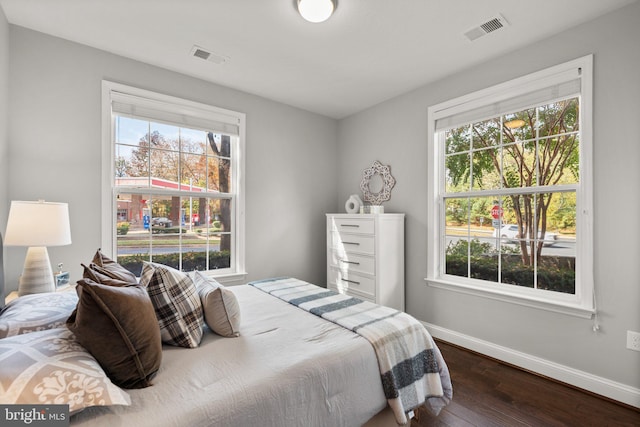 bedroom featuring multiple windows and hardwood / wood-style flooring