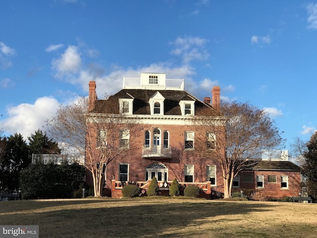 colonial home with a front lawn