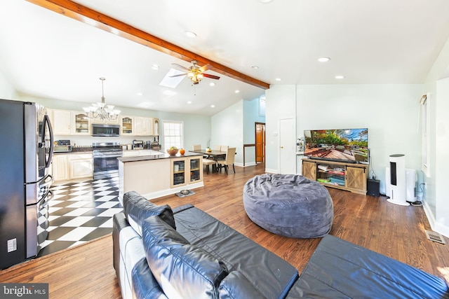 living area with vaulted ceiling with skylight, recessed lighting, baseboards, and dark wood-type flooring