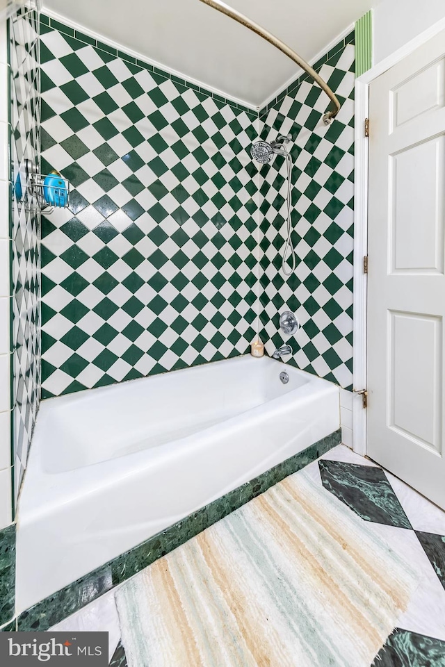 bathroom featuring tub / shower combination and wood finished floors