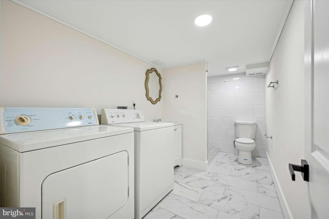 laundry room with tile walls and washer and clothes dryer