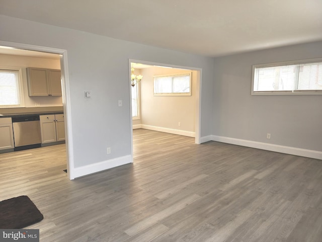 unfurnished living room with light wood finished floors and baseboards