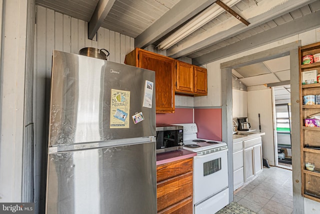 kitchen with stainless steel appliances, wooden walls, and beamed ceiling