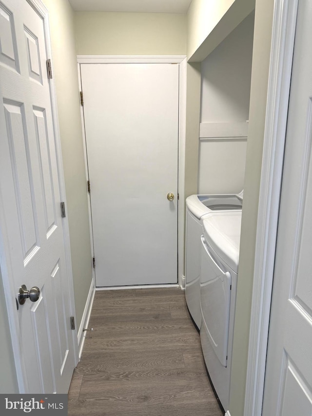 laundry area with washing machine and dryer and dark hardwood / wood-style floors