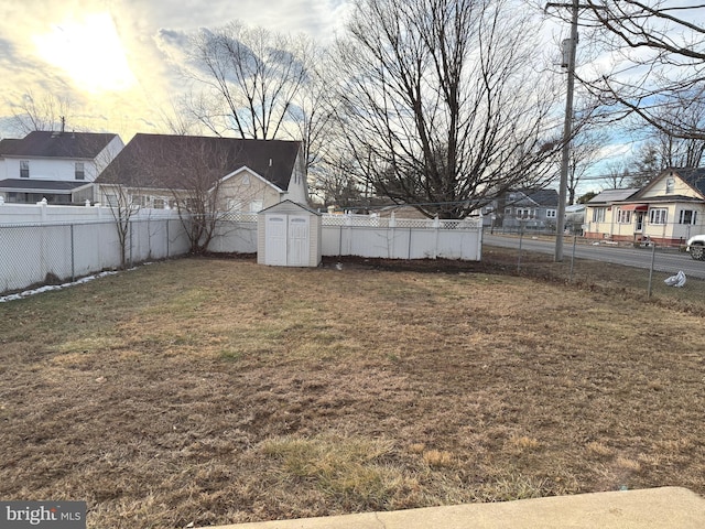 yard at dusk with a storage shed