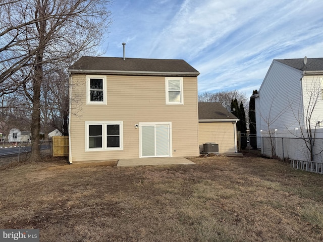 rear view of house featuring a patio, central AC unit, and a lawn