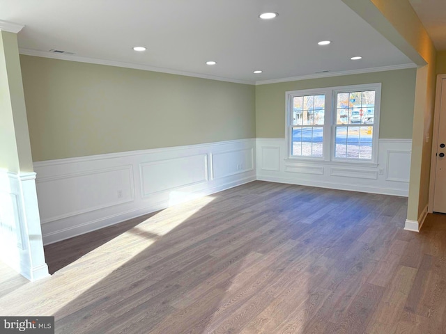 empty room with dark wood-type flooring and ornamental molding