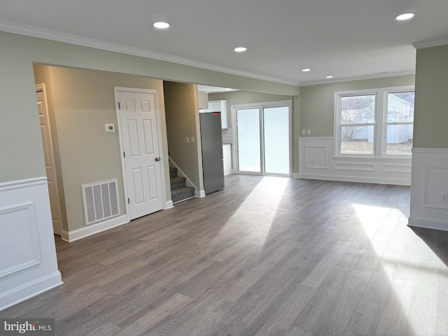 empty room featuring dark wood-type flooring and crown molding