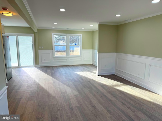 spare room featuring ornamental molding and dark wood-type flooring