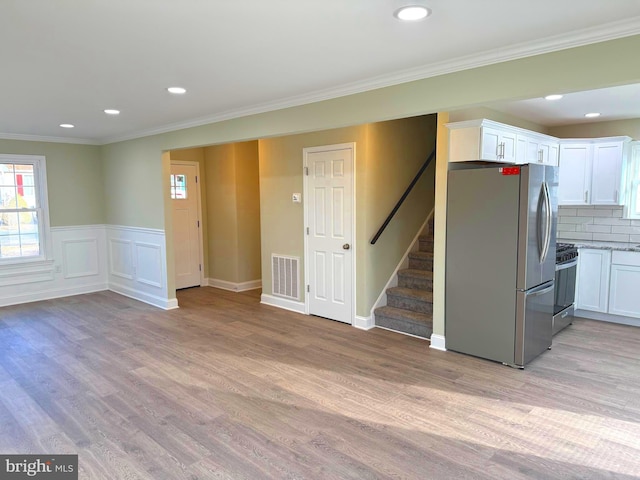 interior space featuring crown molding and light wood-type flooring