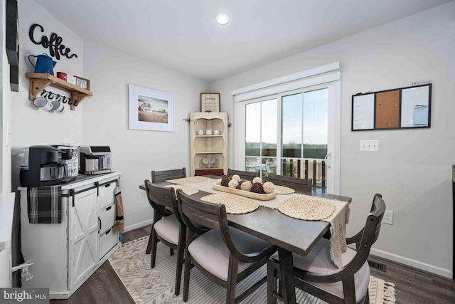 dining space with hardwood / wood-style flooring