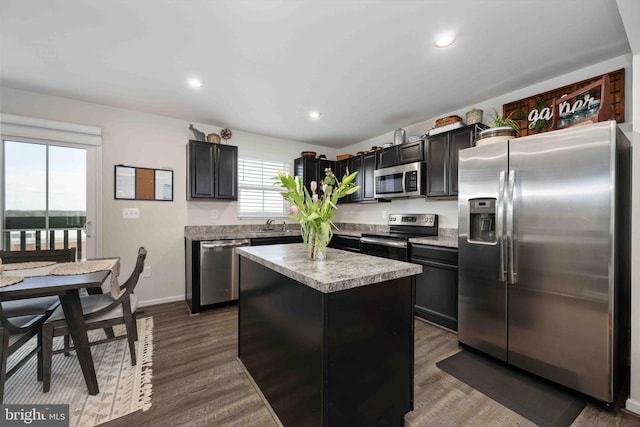 kitchen featuring dark hardwood / wood-style floors, appliances with stainless steel finishes, and a center island