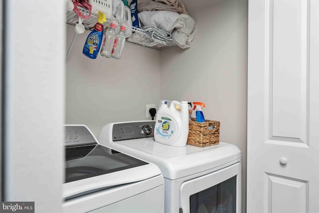 clothes washing area featuring separate washer and dryer