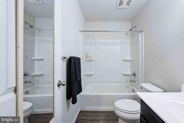 full bathroom featuring vanity, bathing tub / shower combination, toilet, and hardwood / wood-style floors