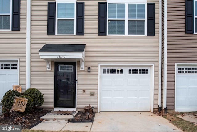 view of exterior entry with a garage