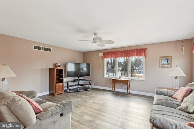 living room with hardwood / wood-style flooring and ceiling fan