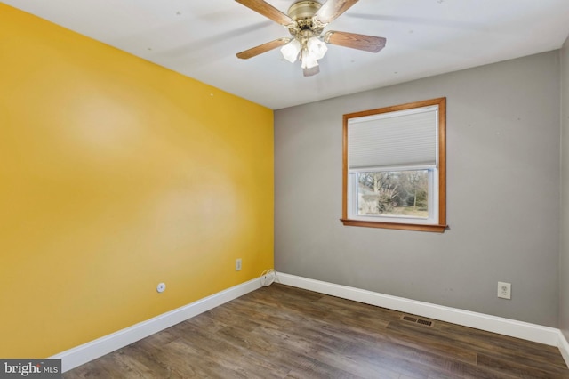 empty room with dark wood-type flooring and ceiling fan