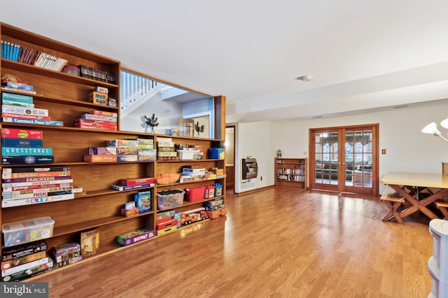 interior space with french doors and light hardwood / wood-style flooring