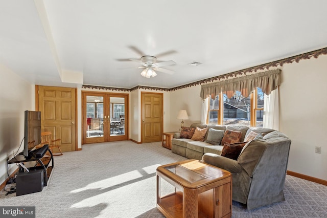 carpeted living room with french doors and ceiling fan