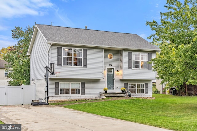 raised ranch featuring a front lawn