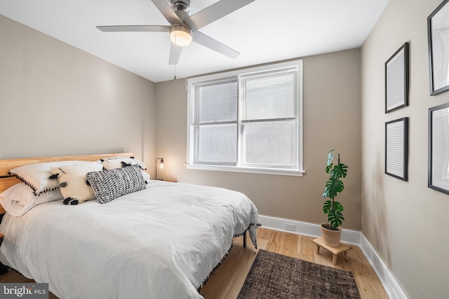 bedroom featuring hardwood / wood-style floors and ceiling fan