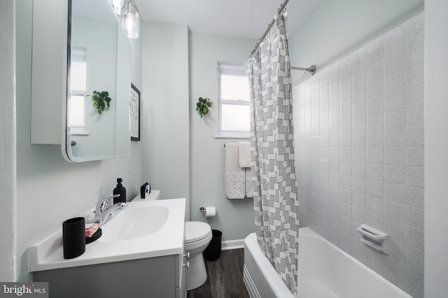 full bathroom with shower / tub combo, hardwood / wood-style floors, vanity, and toilet