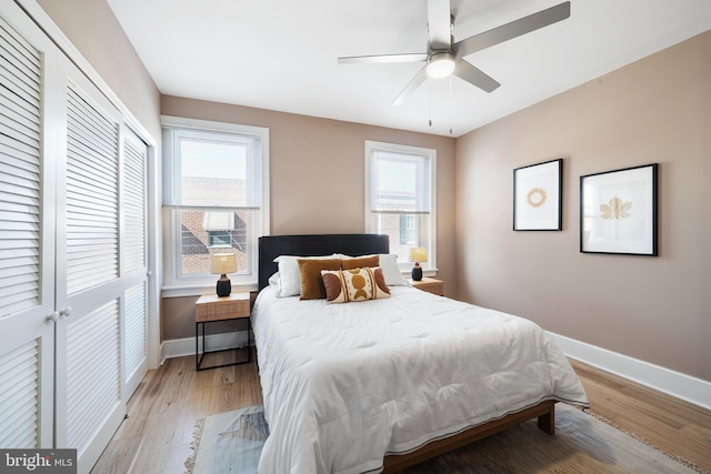 bedroom with light hardwood / wood-style flooring, a closet, and ceiling fan