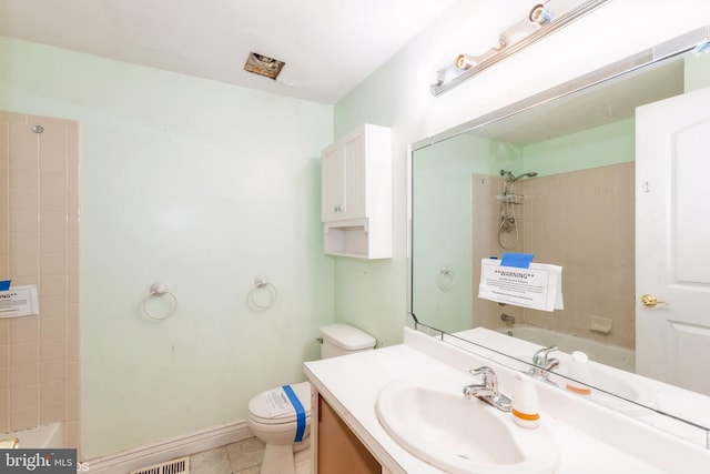 full bathroom featuring tiled shower / bath, vanity, toilet, and tile patterned floors