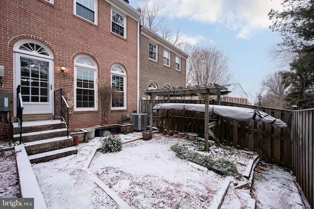 exterior space with brick siding, entry steps, central AC, fence, and a pergola